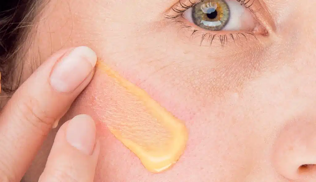 100% Pure Singapore main woman swiping serum onto skin.jpg 2